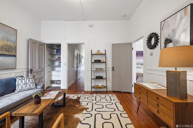 a bedroom with furniture and a flat screen tv