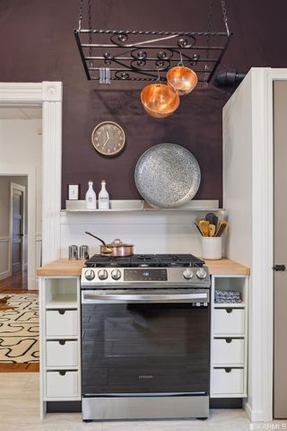 a stove top oven sitting inside of a kitchen
