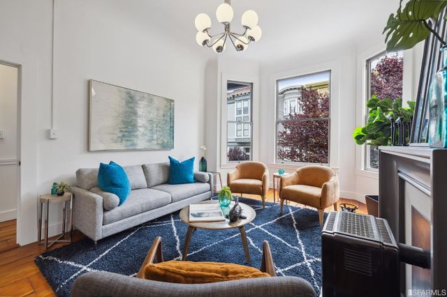 a living room with furniture a rug and a window