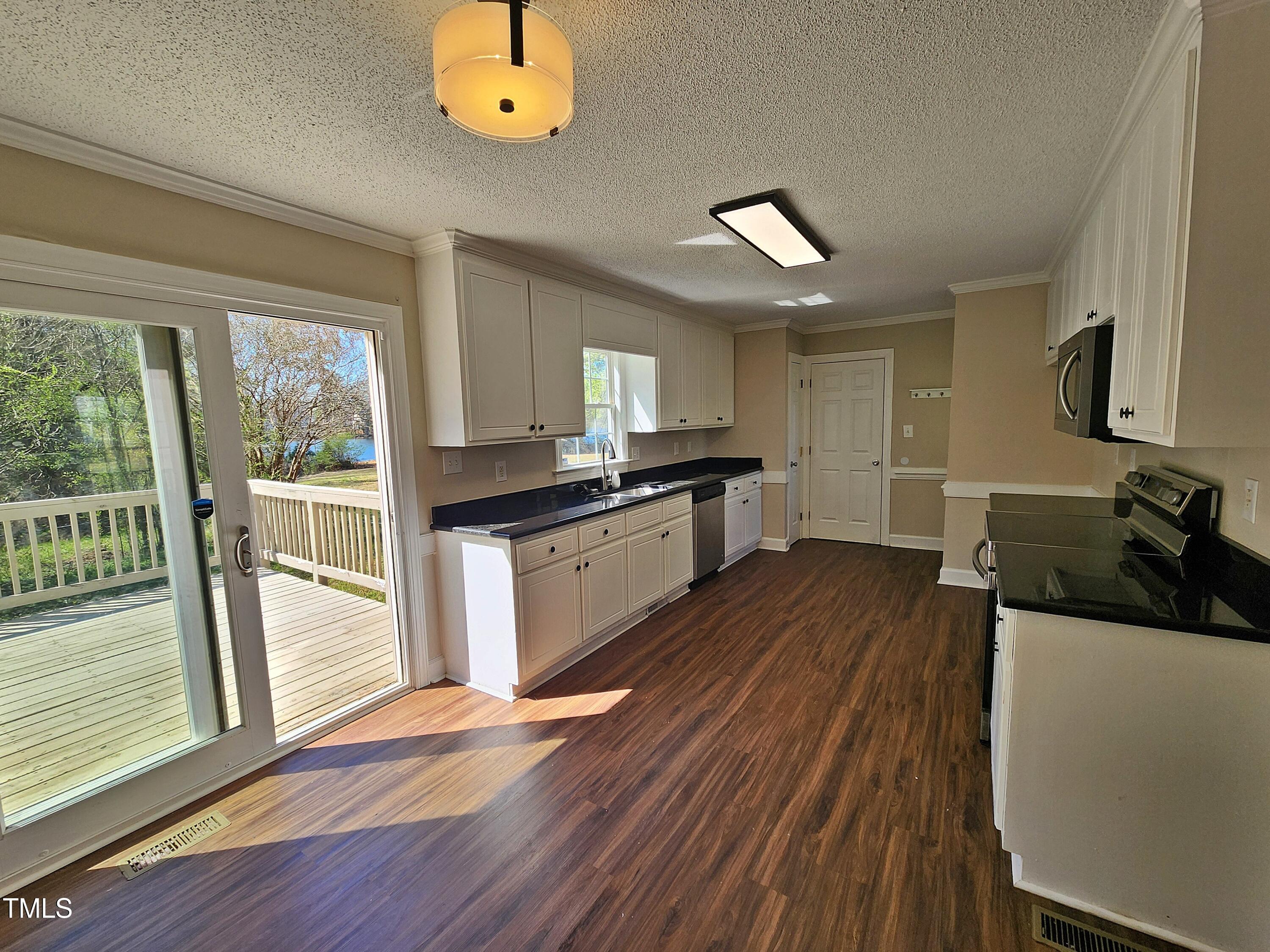 120 Keith Court Willow Spring, NC 27592 - Photo 11 of 25 a kitchen with a sink and wooden floor