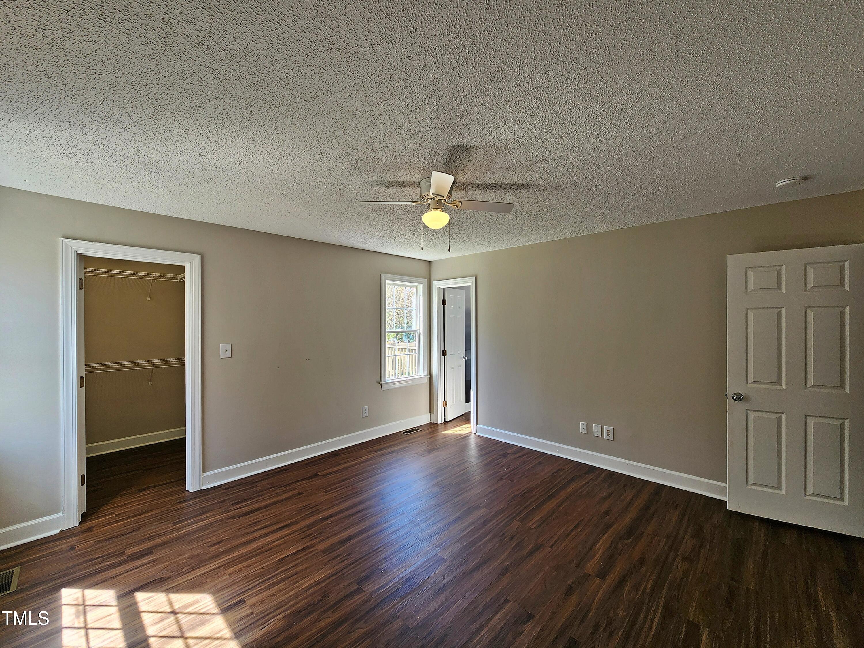 120 Keith Court Willow Spring, NC 27592 - Photo 15 of 25 a view of an empty room with wooden floor and a window
