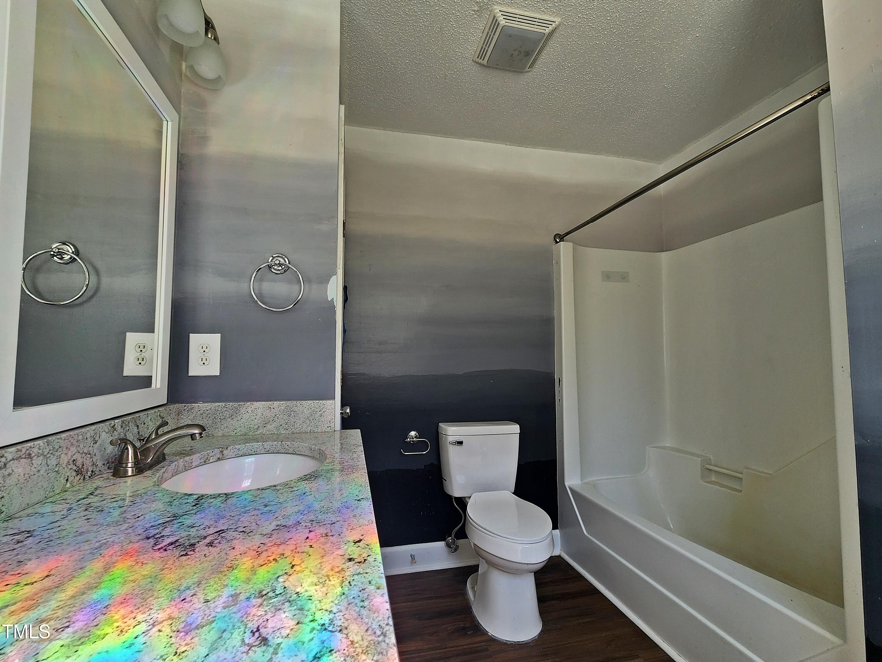 120 Keith Court Willow Spring, NC 27592 - Photo 17 of 25 a bathroom with a granite countertop sink and a mirror