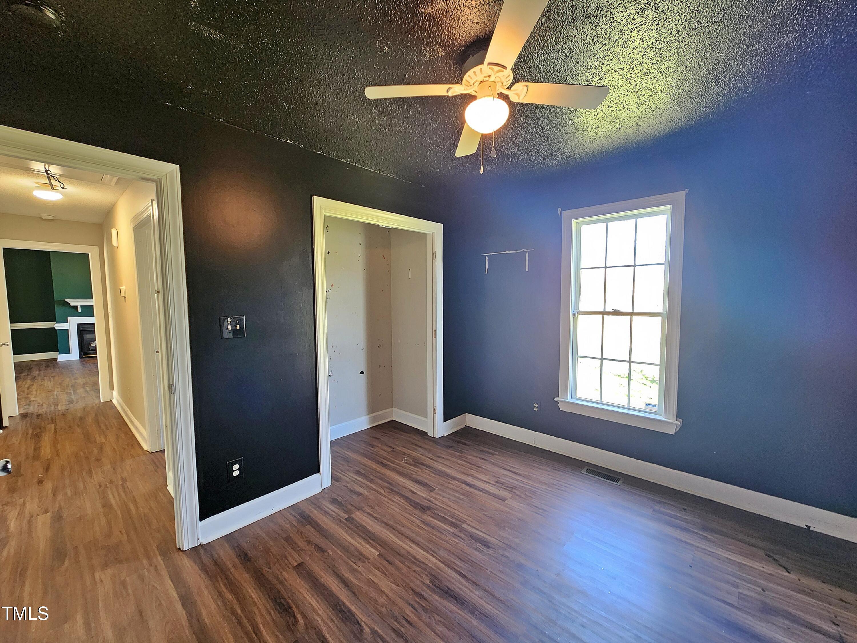 120 Keith Court Willow Spring, NC 27592 - Photo 19 of 25 an empty room with wooden floor chandelier fan and windows