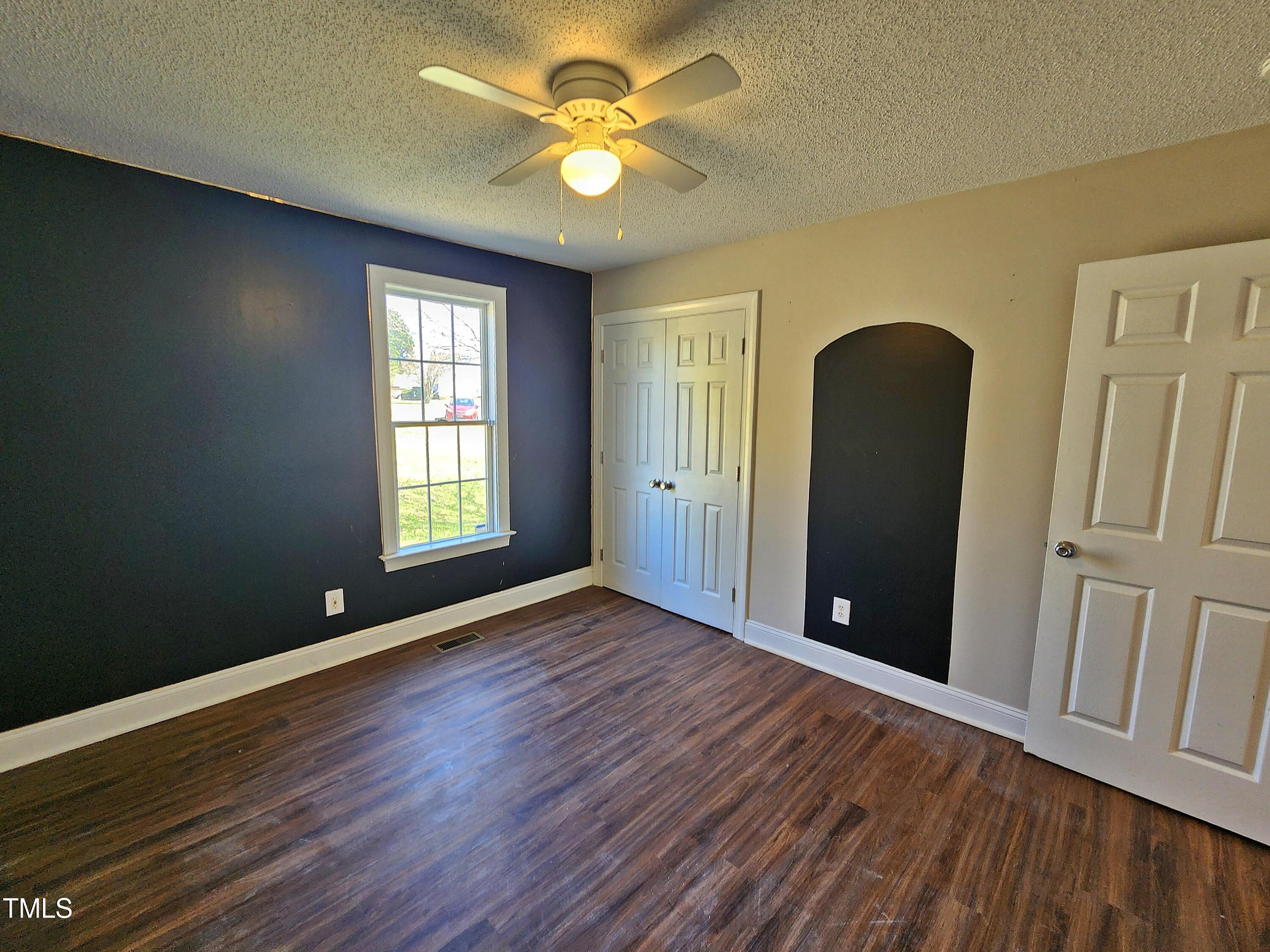 120 Keith Court Willow Spring, NC 27592 - Photo 21 of 25 a view of an empty room with window and wooden floor