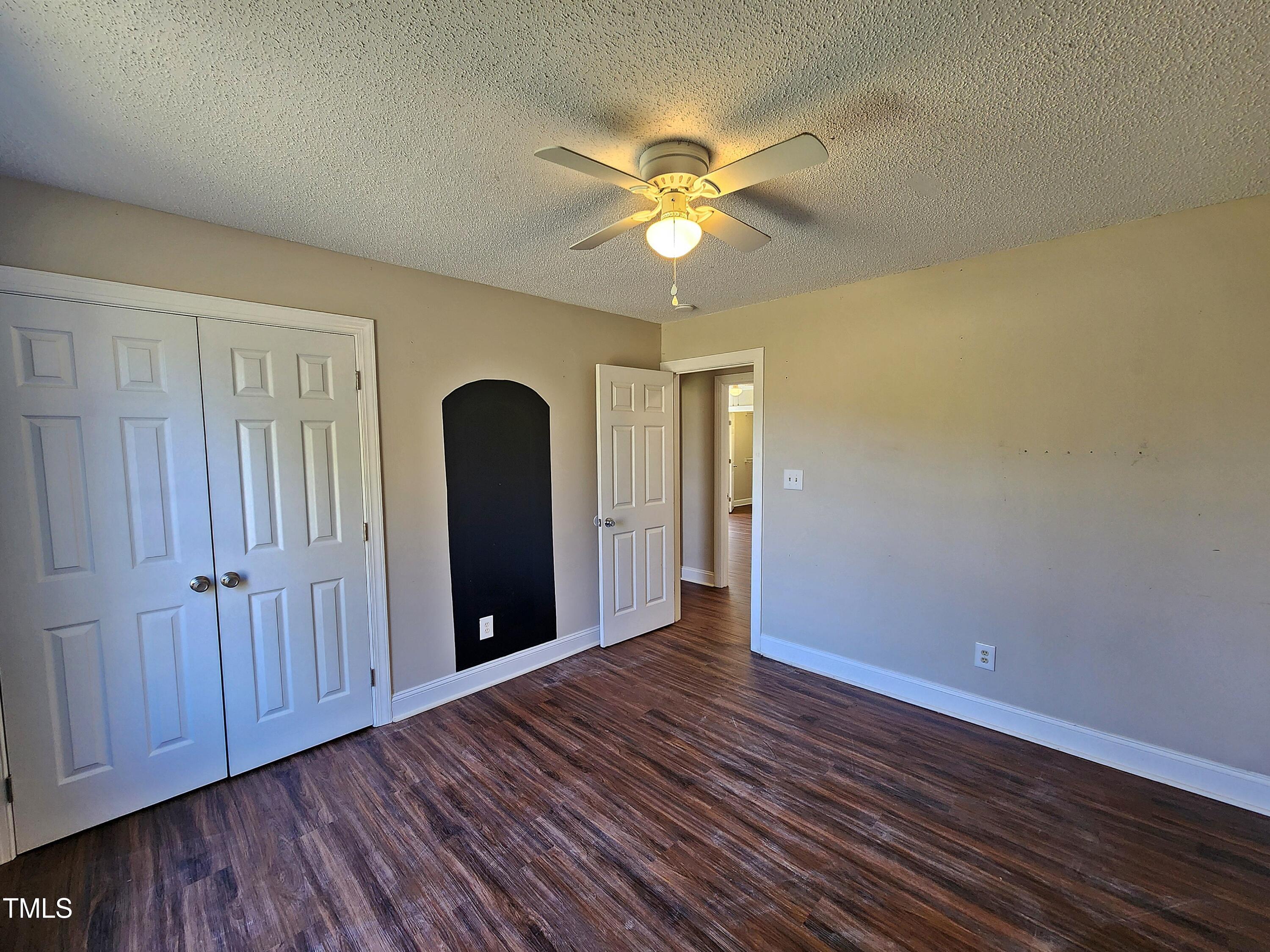 120 Keith Court Willow Spring, NC 27592 - Photo 22 of 25 an empty room with wooden floor closet and windows