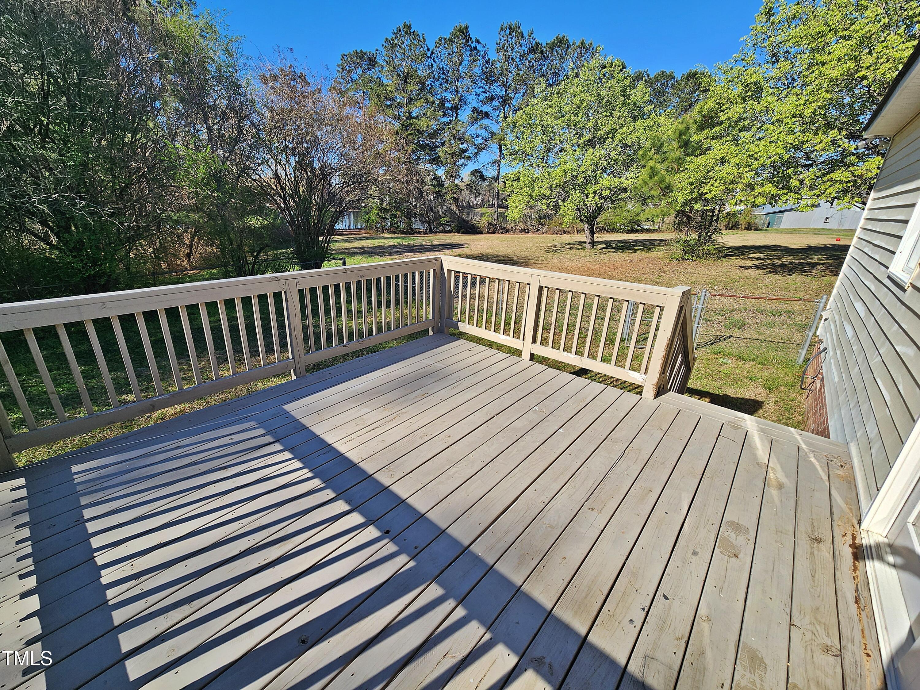 120 Keith Court Willow Spring, NC 27592 - Photo 4 of 25 a view of balcony with wooden floor and fence