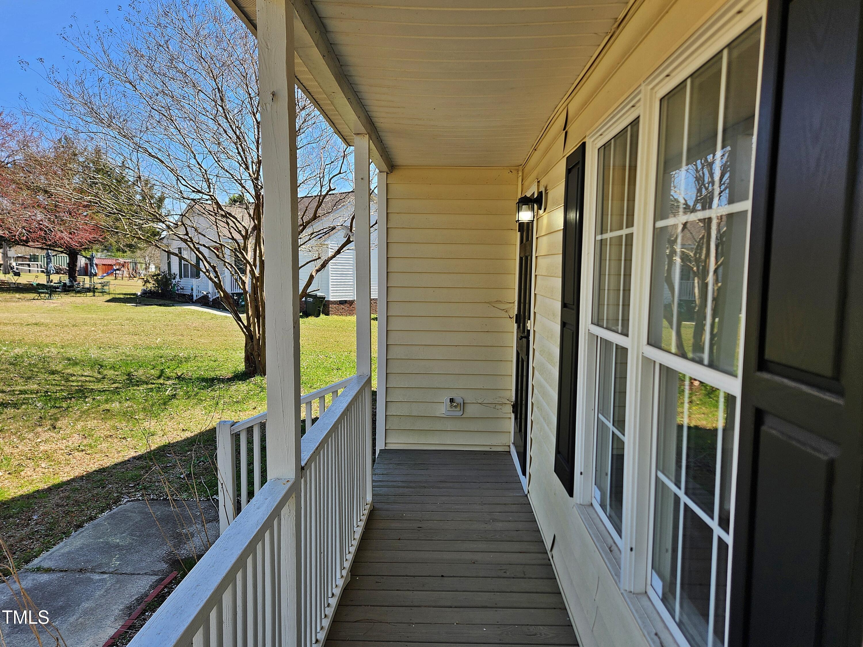 120 Keith Court Willow Spring, NC 27592 - Photo 7 of 25 a view of a balcony with wooden floor and fence