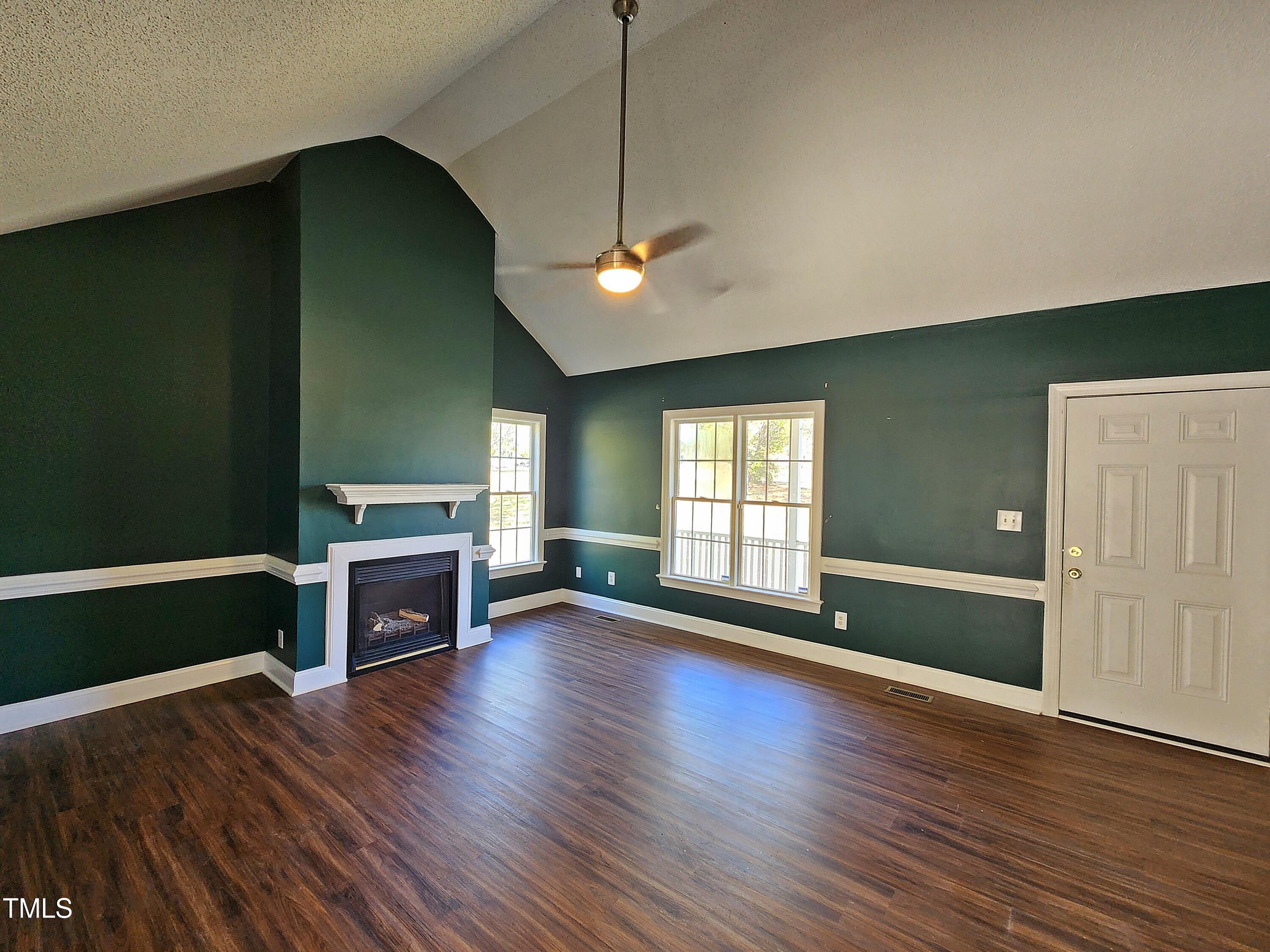 120 Keith Court Willow Spring, NC 27592 - Photo 8 of 25 a view of empty room with a fireplace and wooden floor
