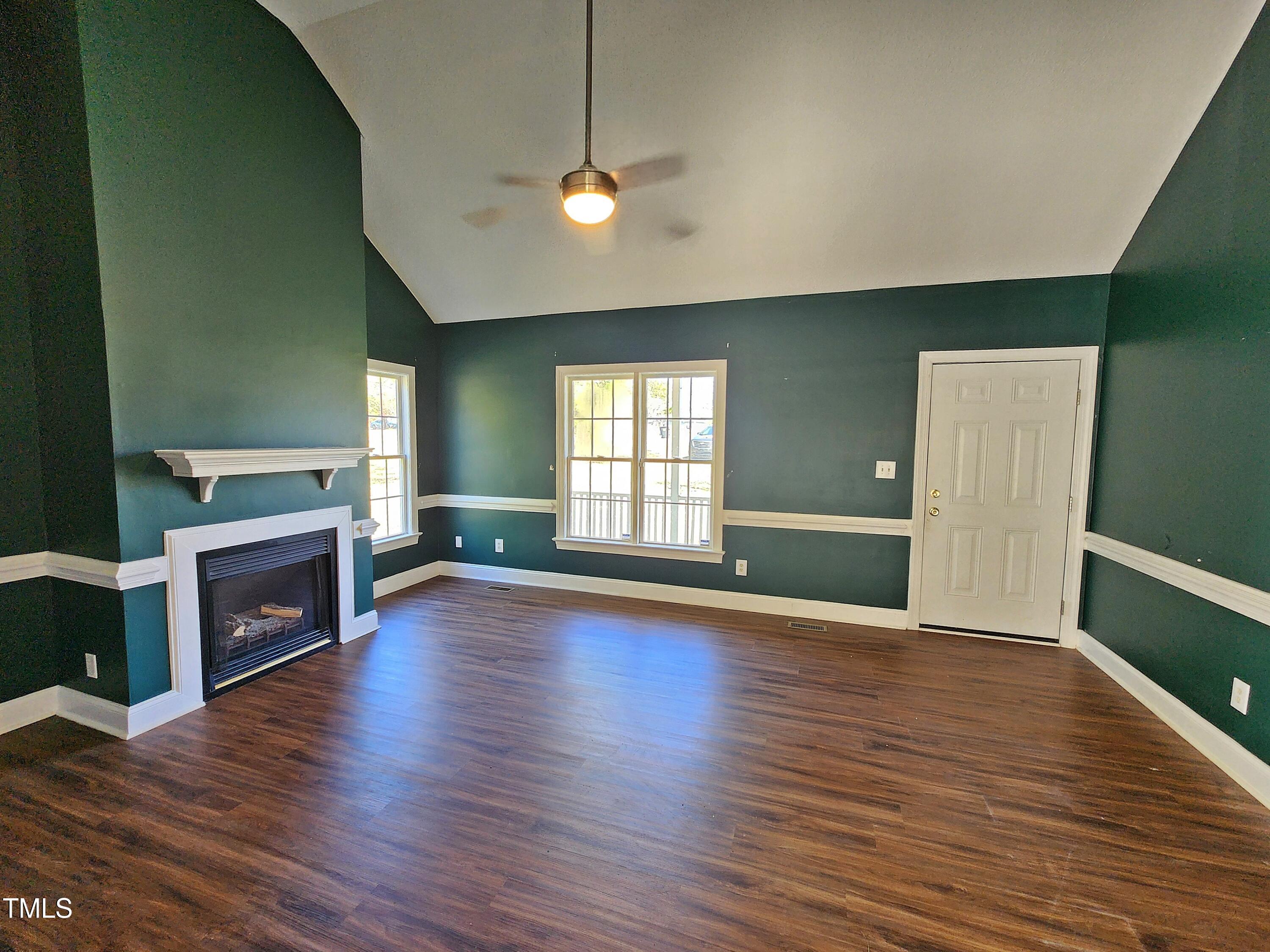 120 Keith Court Willow Spring, NC 27592 - Photo 9 of 25 a view of an empty room with a window and fireplace
