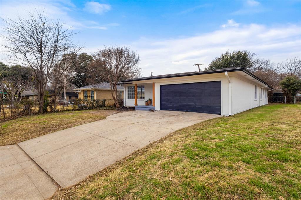 1917 South Vernon Avenue Dallas, TX 75224 - Photo 2 of 28 Single-story residence featuring a white exterior, a dark garage door, and a concrete driveway