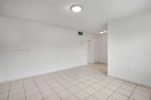 an empty room with white wall