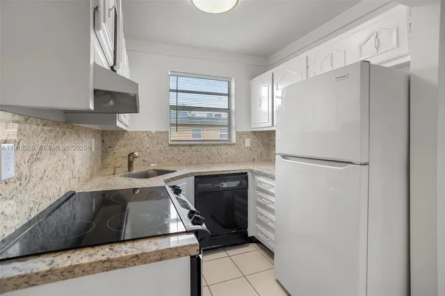 a kitchen with a refrigerator and a stove