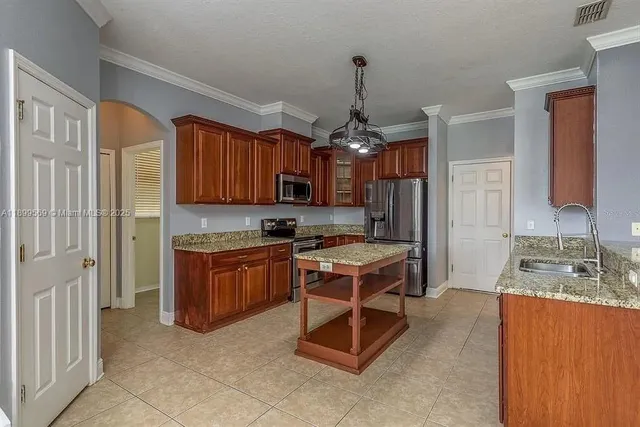 a kitchen with a sink appliances and cabinets