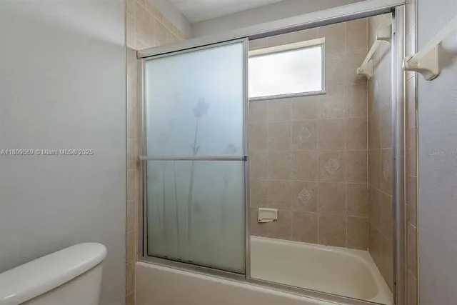 a bathroom with a shower and a toilet