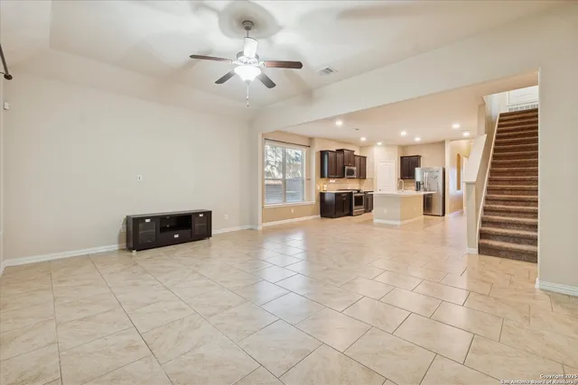 a view of a livingroom with furniture and a ceiling fan