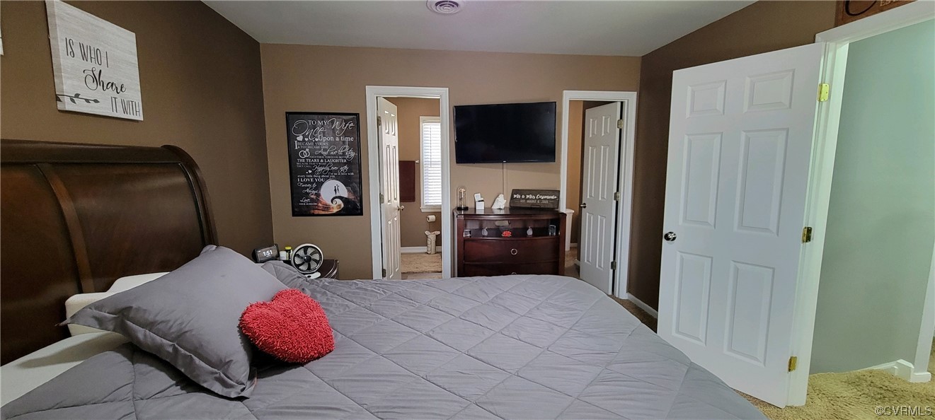 4924 Old Logging Circle Prince George, VA 23875 - Photo 17 of 22 a bedroom with a bed and a flat screen tv