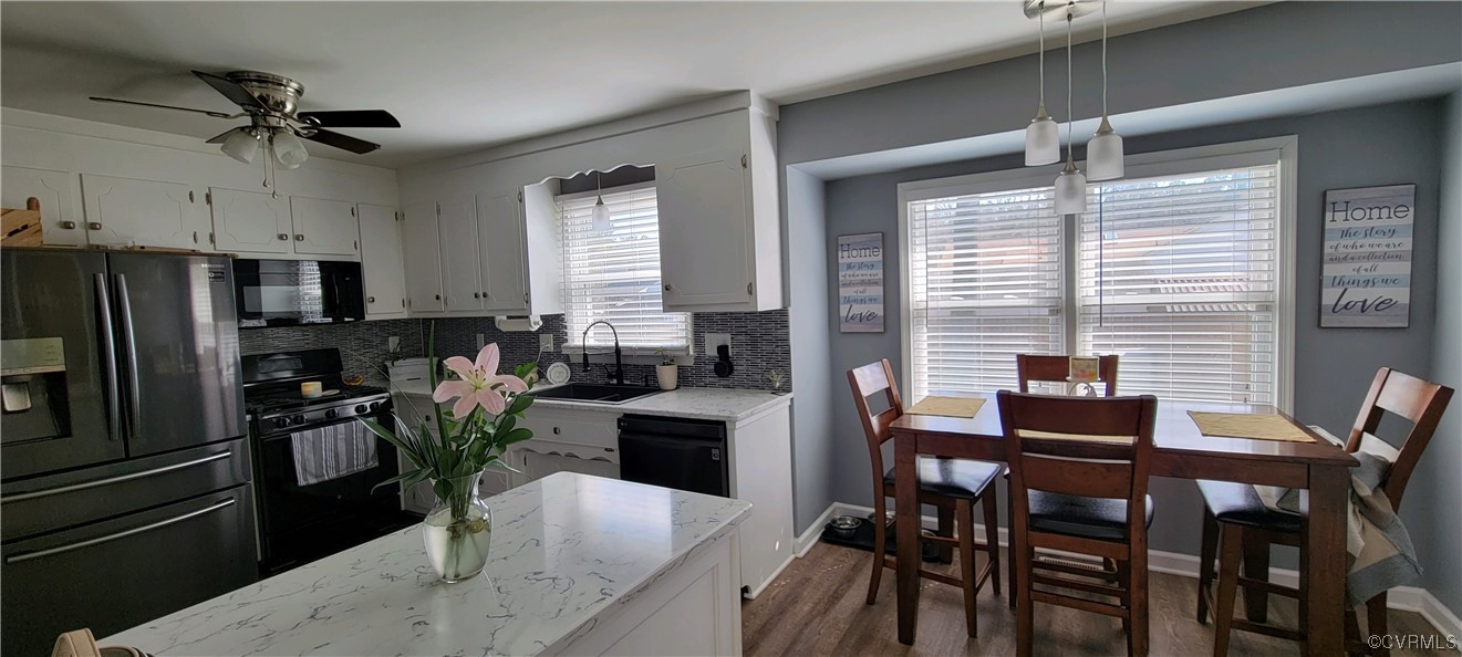 4924 Old Logging Circle Prince George, VA 23875 - Photo 9 of 22 a kitchen with a table chairs refrigerator and microwave