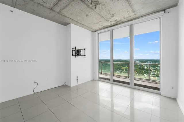 a view of empty room with floor to ceiling window