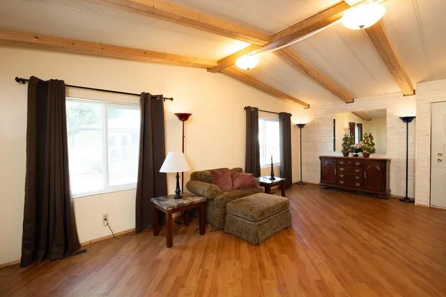 a dining room with furniture potted plants and wooden floor