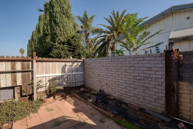 a view of a house with a big yard and potted plants