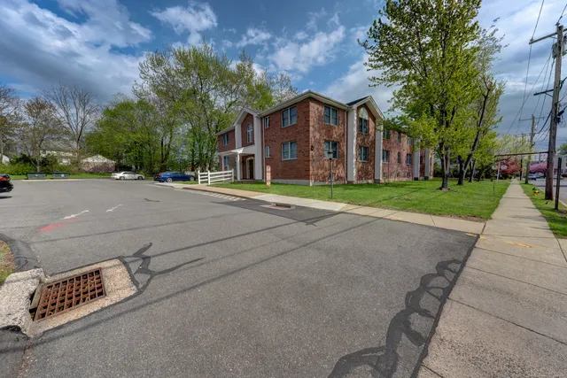 a view of a street with brick building in front of it