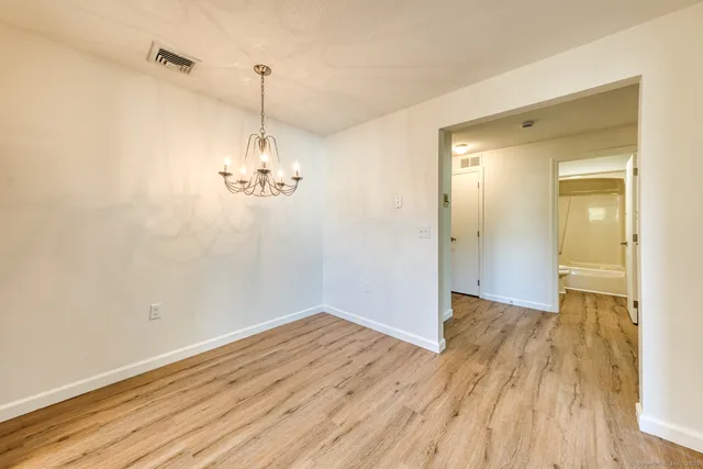 a view of a room with wooden floor and windows
