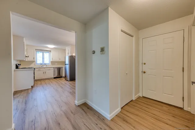 a view of a kitchen with wooden floor and a sink
