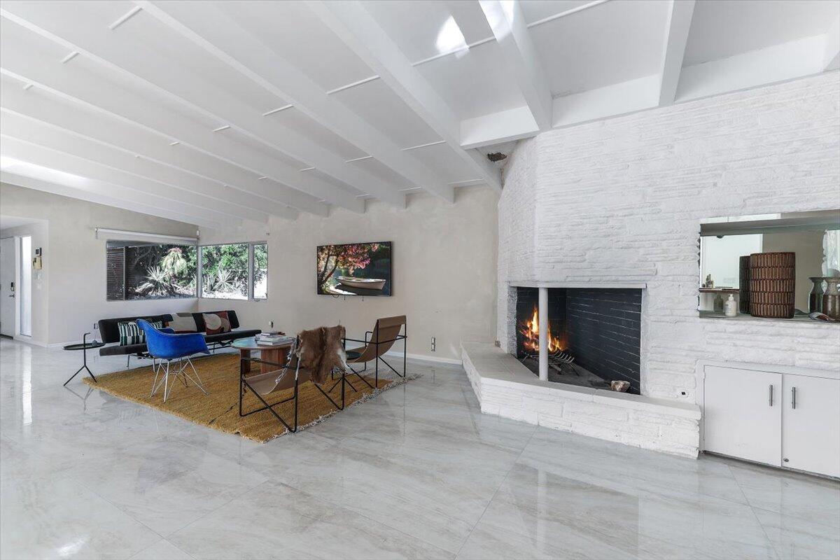 447 West Mariscal Road Palm Springs, CA 92262 - Photo 13 of 22 a living room with furniture and a fireplace