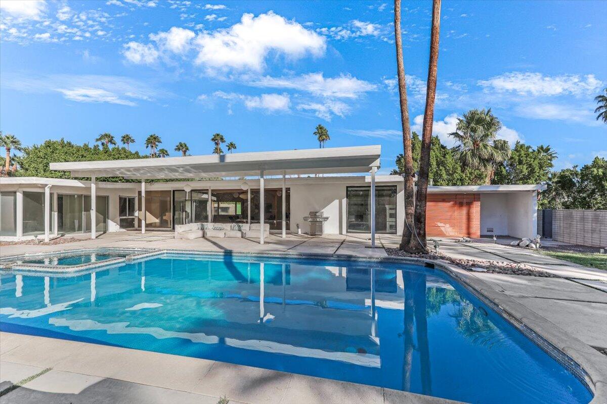 447 West Mariscal Road Palm Springs, CA 92262 - Photo 19 of 22 a front view of house with a garden and trees