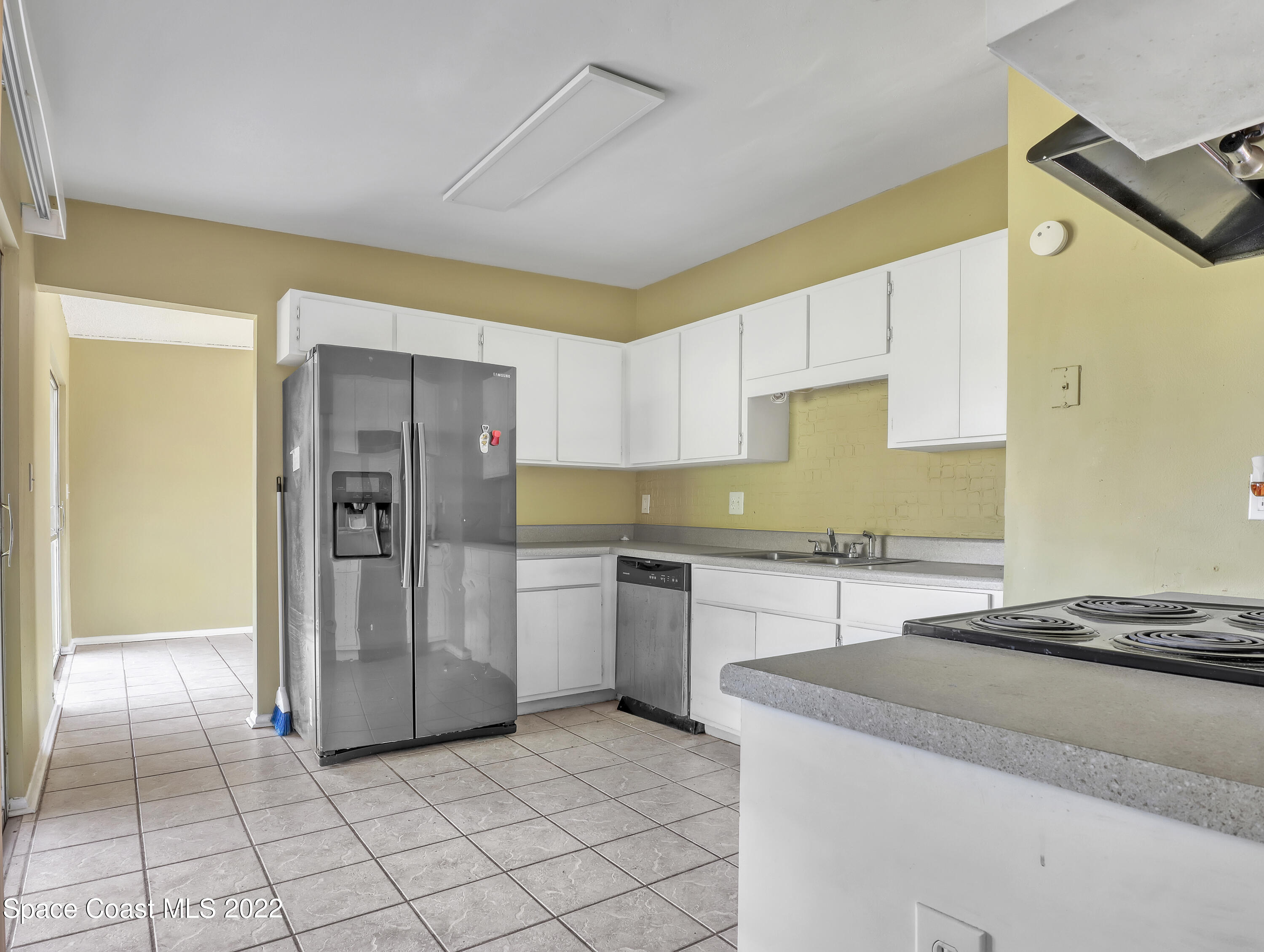 2808 Starlight Circle Northeast Palm Bay, FL 32905 - Photo 14 of 33 a kitchen with a refrigerator and a sink