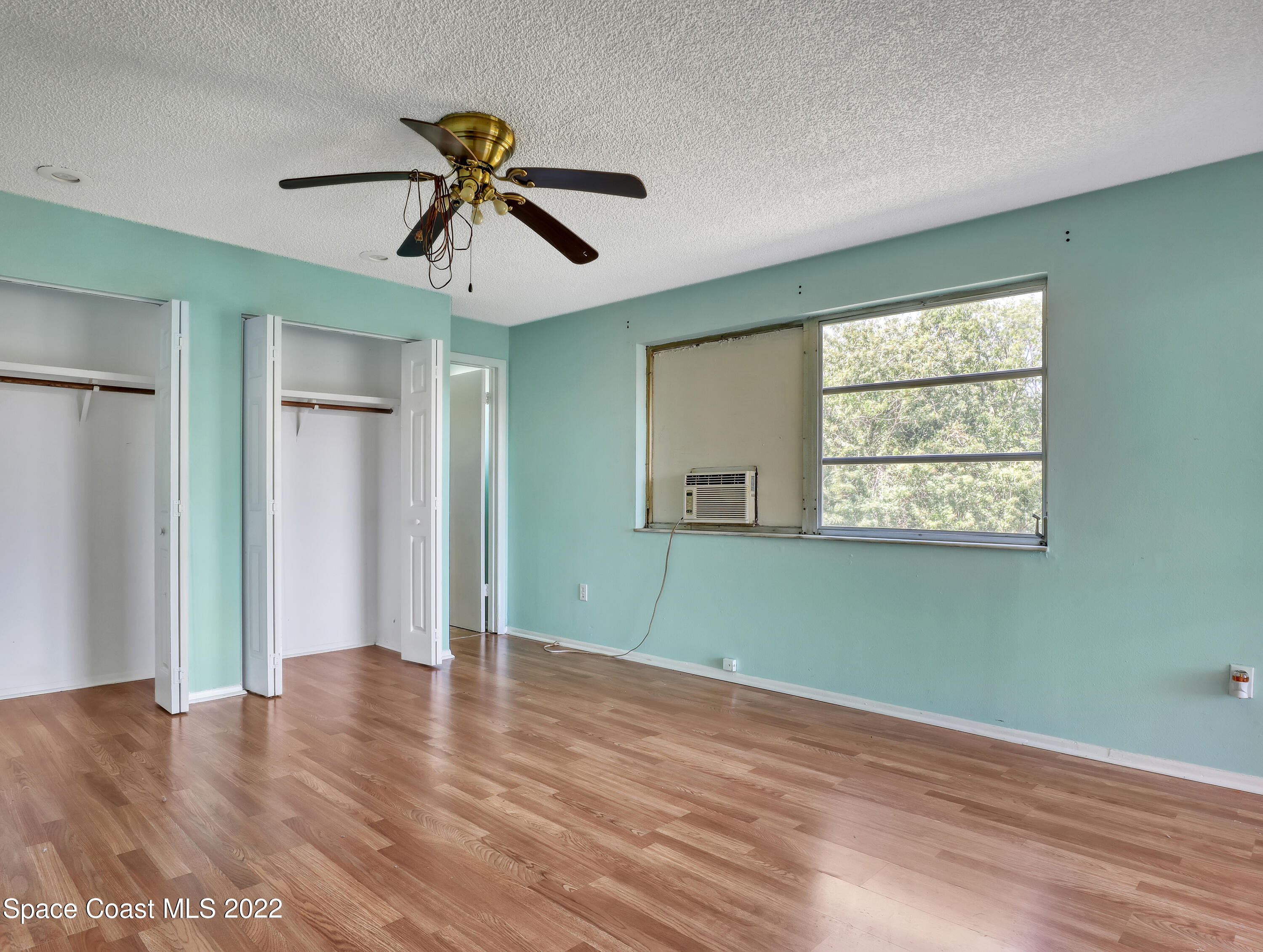 2808 Starlight Circle Northeast Palm Bay, FL 32905 - Photo 16 of 33 a view of empty room with wooden floor and fan