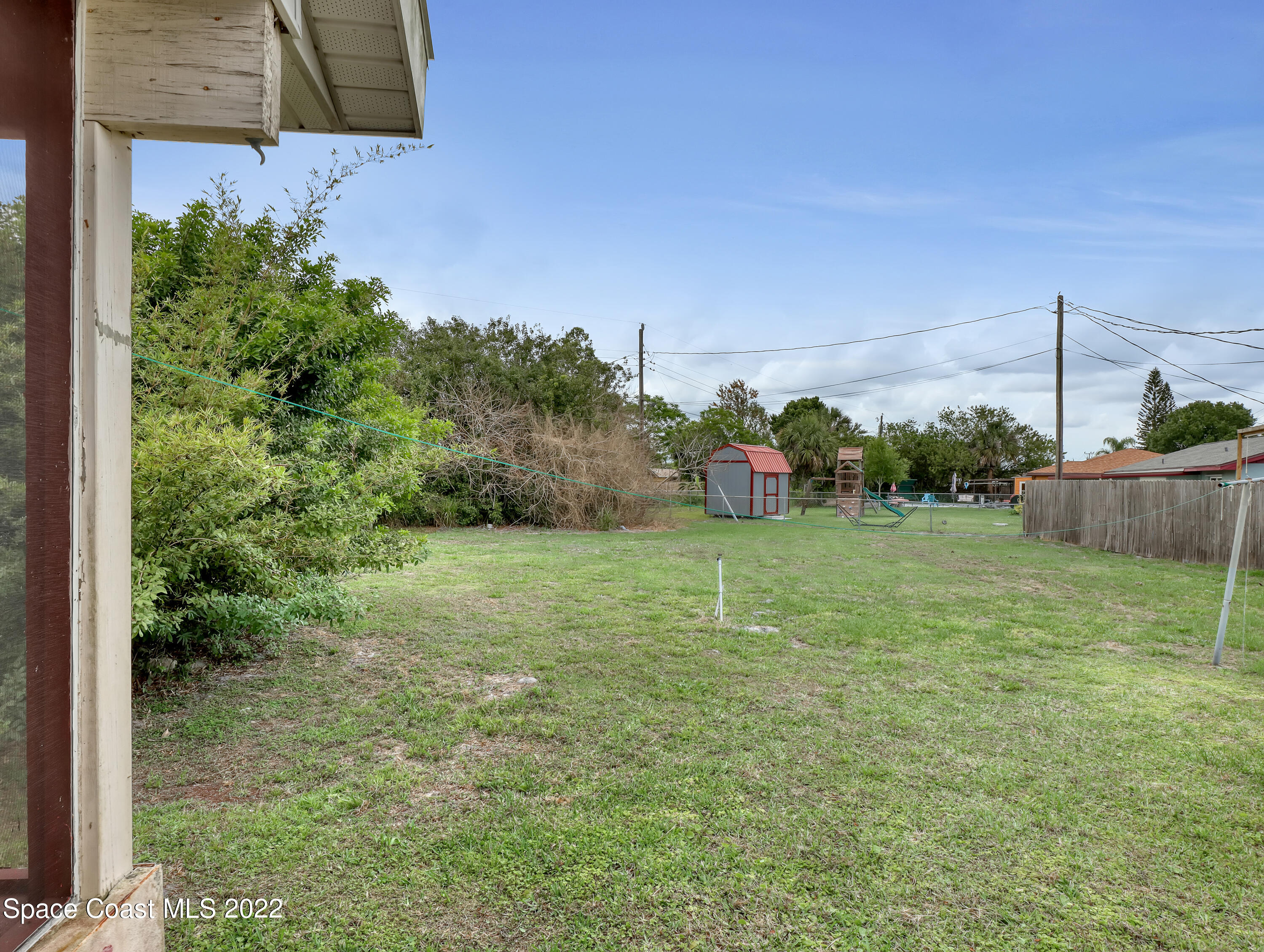 2808 Starlight Circle Northeast Palm Bay, FL 32905 - Photo 29 of 33 a backyard of a house with lots of green space