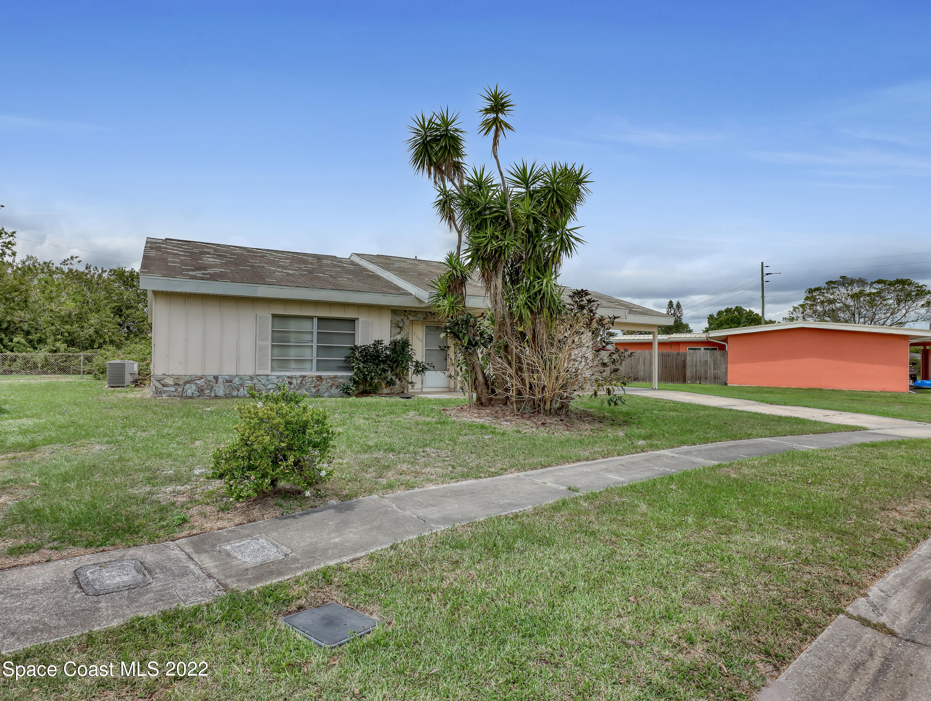 2808 Starlight Circle Northeast Palm Bay, FL 32905 - Photo 3 of 33 a front view of house with yard and trees
