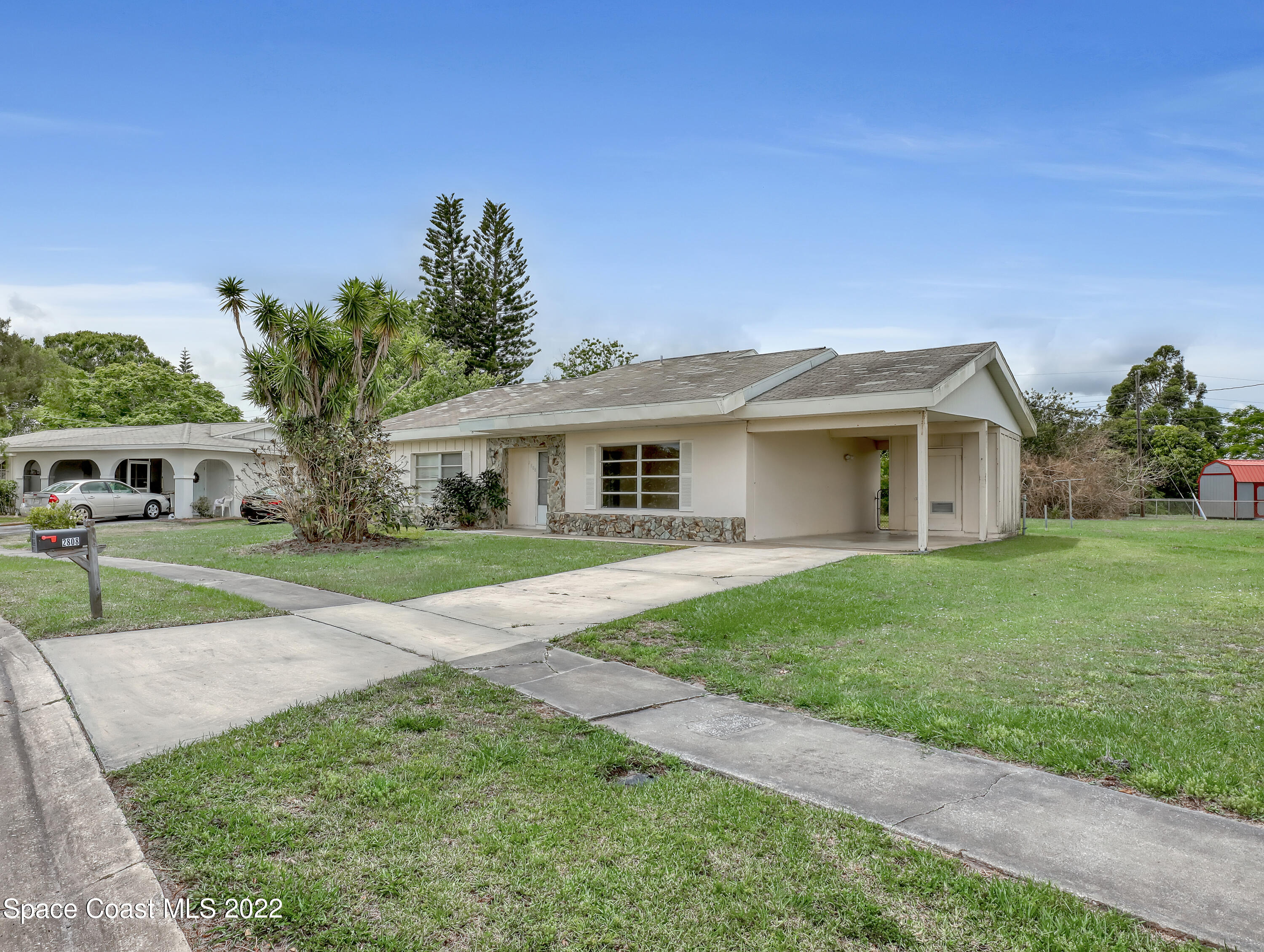 2808 Starlight Circle Northeast Palm Bay, FL 32905 - Photo 4 of 33 a front view of house with yard and green space