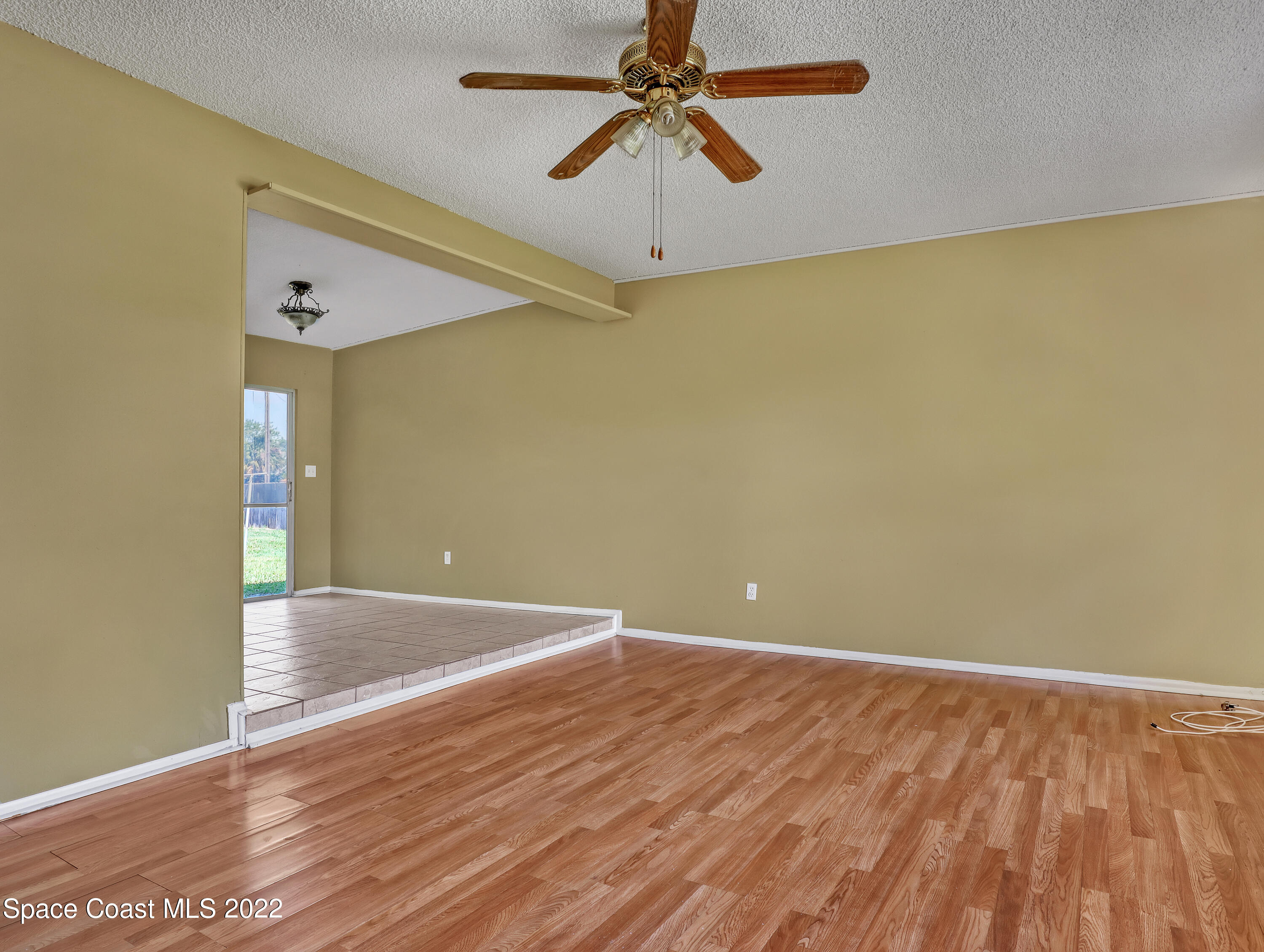 2808 Starlight Circle Northeast Palm Bay, FL 32905 - Photo 7 of 33 a view of an empty room with wooden floor