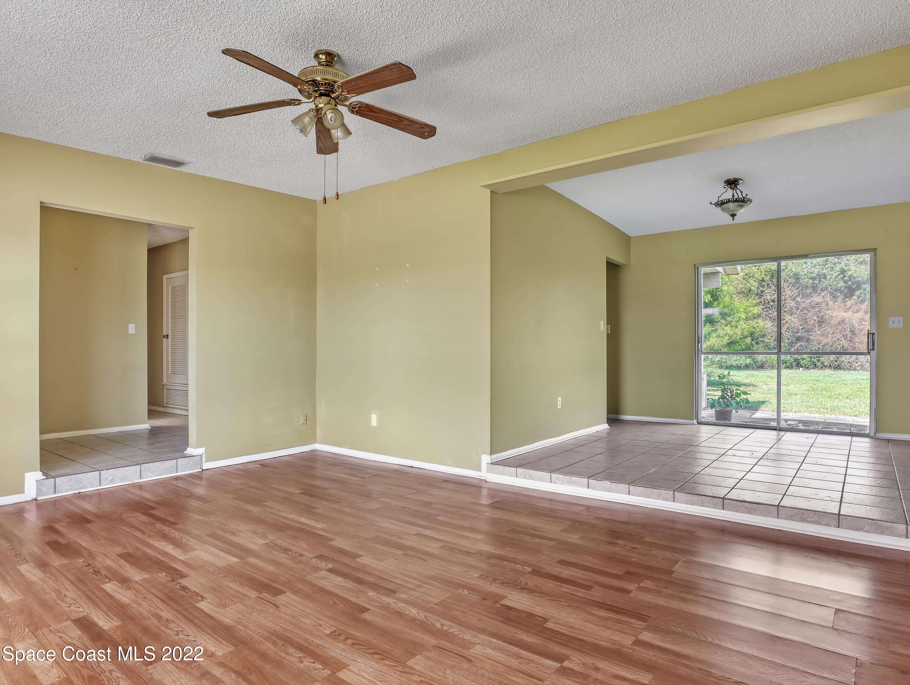 2808 Starlight Circle Northeast Palm Bay, FL 32905 - Photo 9 of 33 a view of empty room with wooden floor and fan