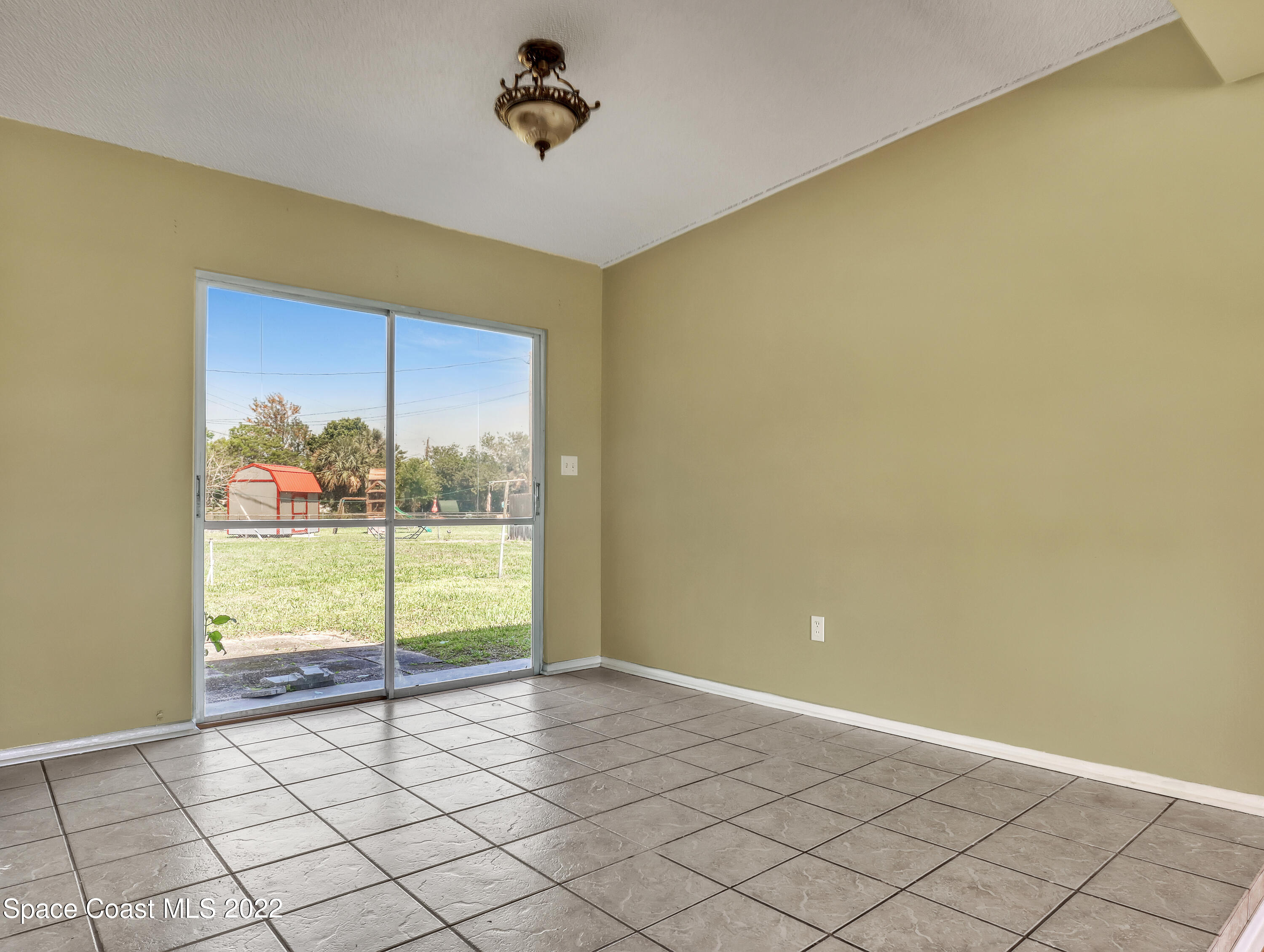 2808 Starlight Circle Northeast Palm Bay, FL 32905 - Photo 10 of 33 a view of an empty room with a window
