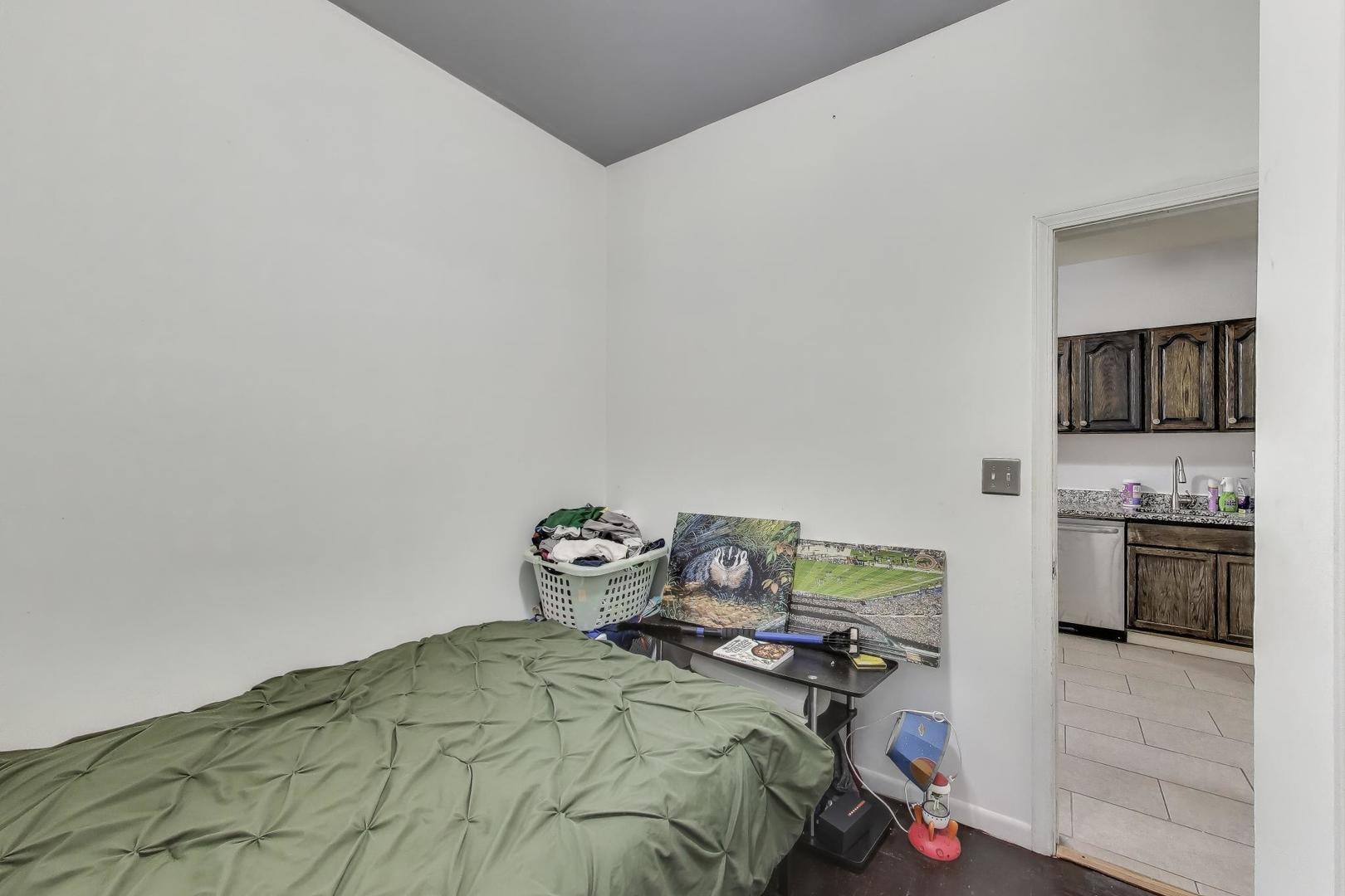 1845 North Albany Avenue, Unit 1 Chicago, IL 60647 - Photo 12 of 24 a bedroom with a bed and a television