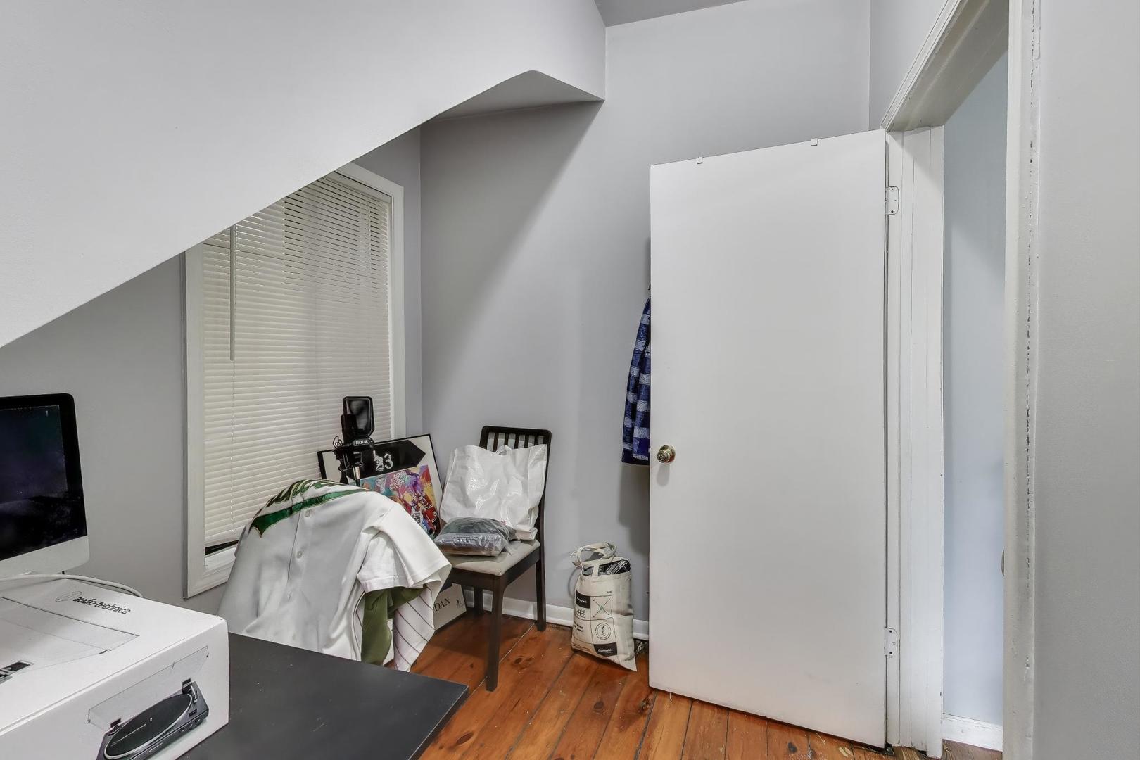 1845 North Albany Avenue, Unit 1 Chicago, IL 60647 - Photo 14 of 24 a bedroom with a bed and a table in it