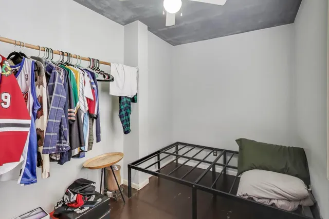 a living room with lots of clothes and shoes