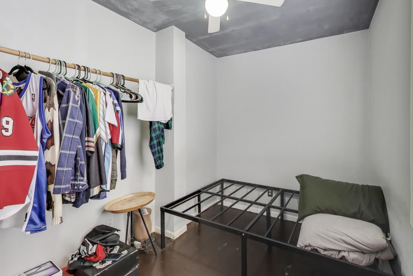 1845 North Albany Avenue, Unit 1 Chicago, IL 60647 - Photo 15 of 24 a living room with lots of clothes and shoes