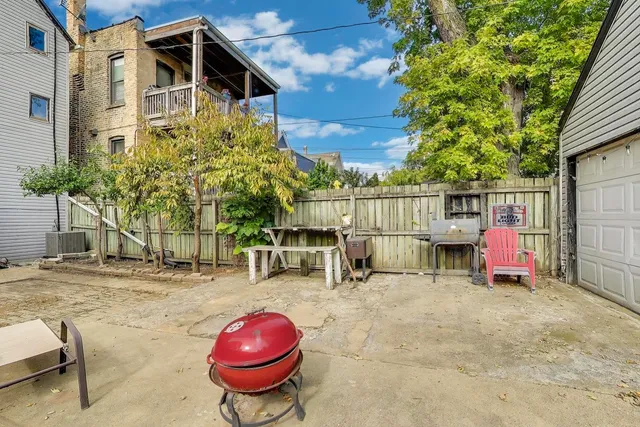 a view of a chairs and table in backyard