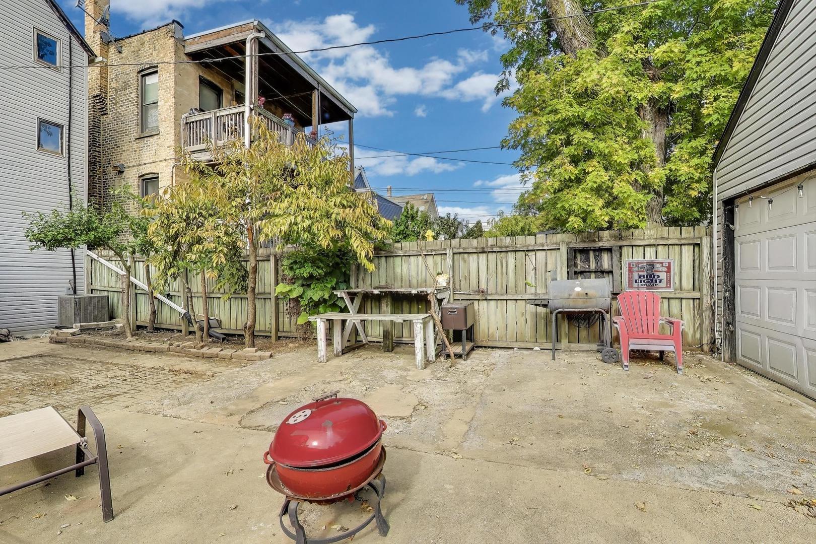 1845 North Albany Avenue, Unit 1 Chicago, IL 60647 - Photo 21 of 24 a view of a chairs and table in backyard