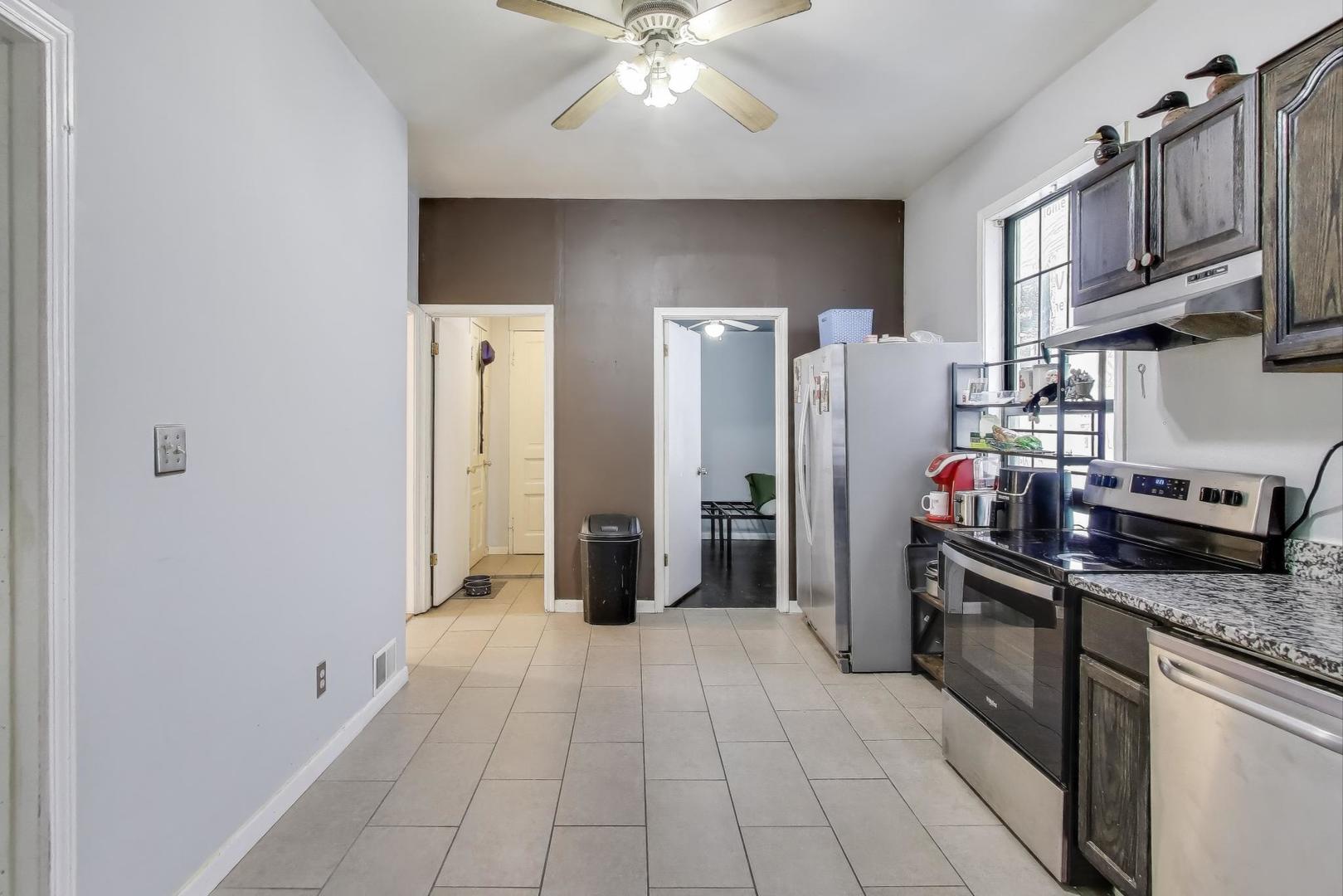 1845 North Albany Avenue, Unit 1 Chicago, IL 60647 - Photo 9 of 24 a kitchen with stainless steel appliances granite countertop a refrigerator a stove and a sink