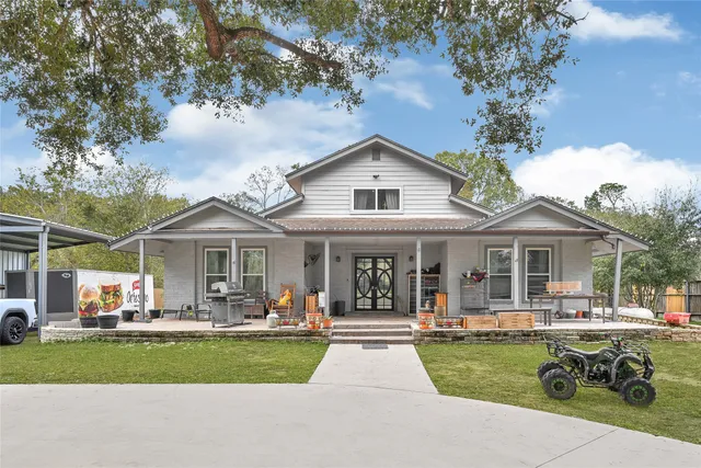 a front view of a house with a yard table and chairs