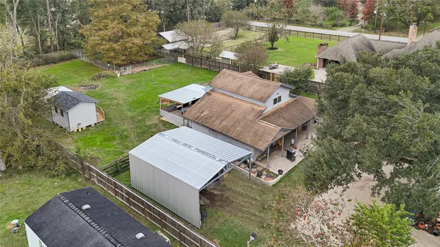 an aerial view of house with yard swimming pool and outdoor seating