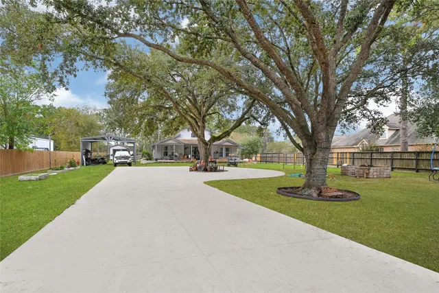 a view of a house with garden and a tree