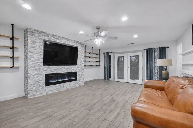 a living room with a flat screen tv and a fireplace