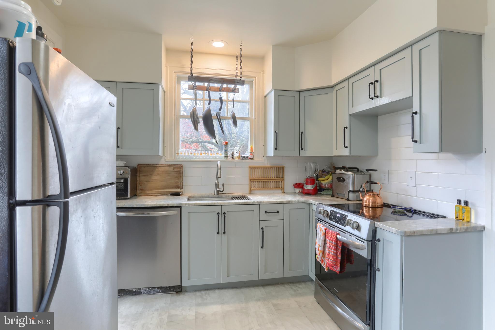 229 Cocoa Avenue Hershey, PA 17033 - Photo 11 of 28 a kitchen with stainless steel appliances granite countertop a refrigerator sink and cabinets
