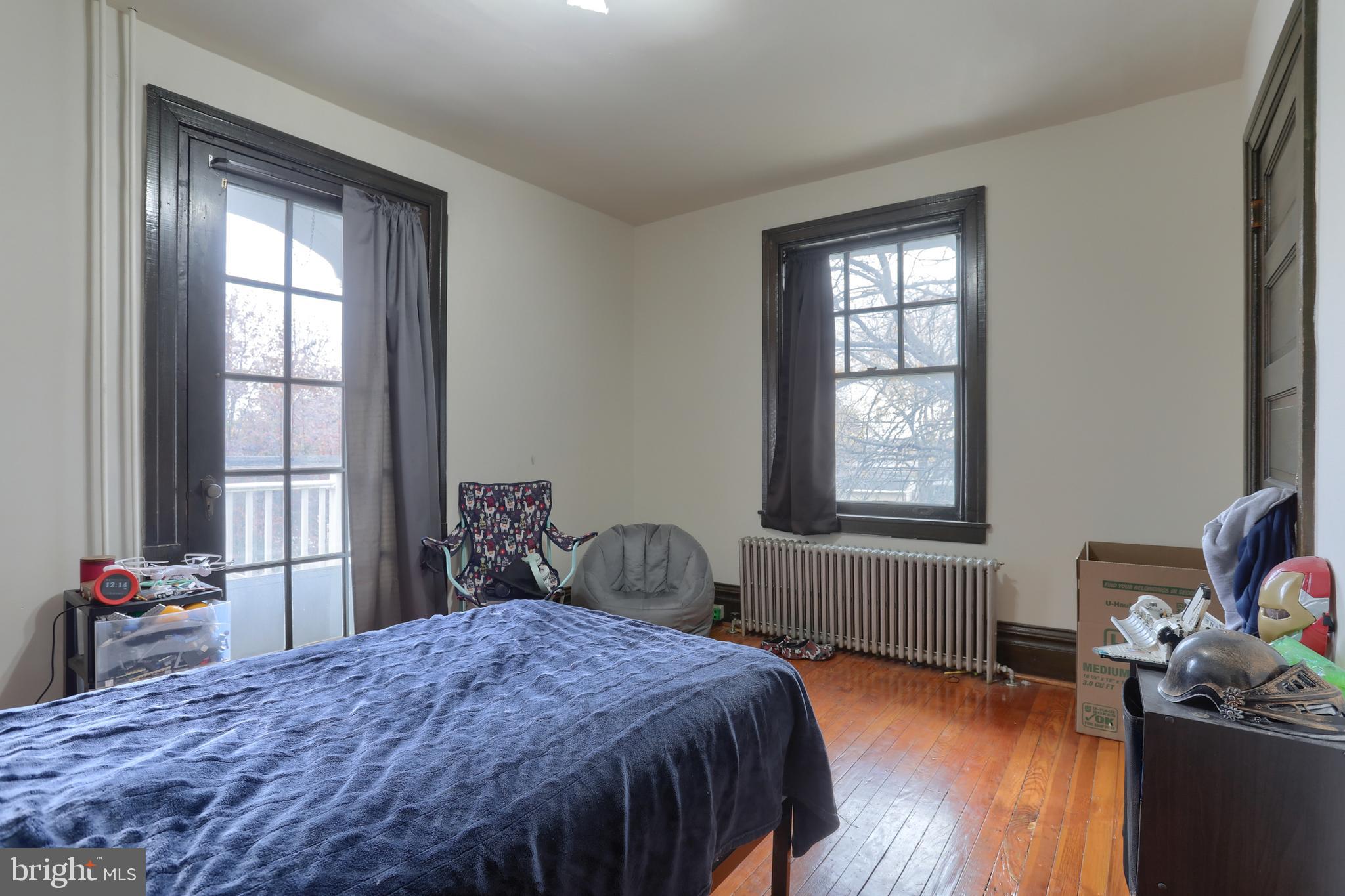 229 Cocoa Avenue Hershey, PA 17033 - Photo 15 of 28 a bedroom with a bed and wooden floor